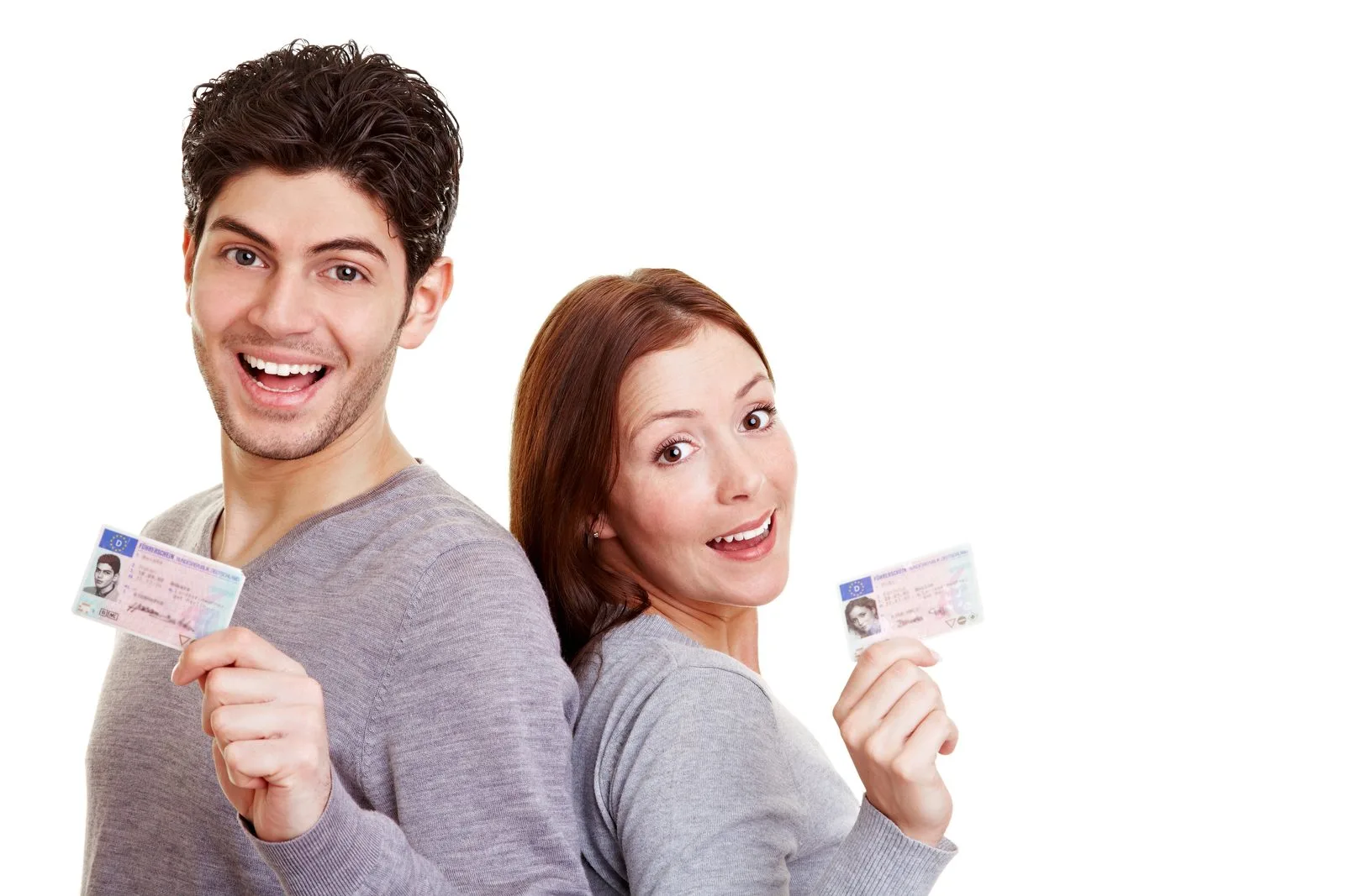 Couple holding driver licences after both passing Alberta Class 5 road test at Orchard Driving School Edmonton