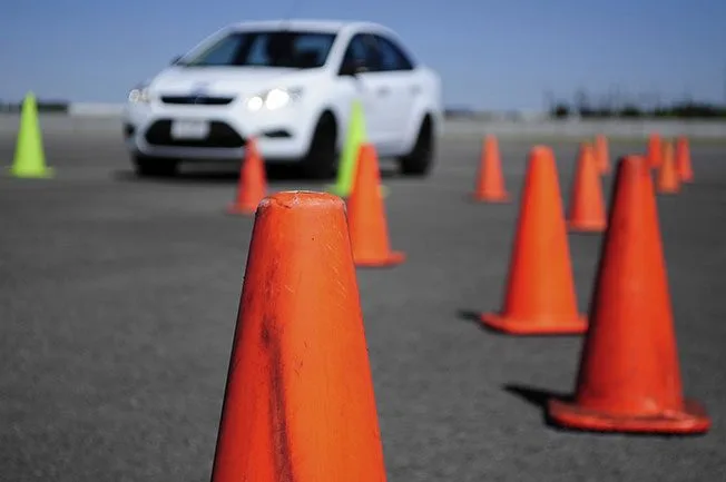 Driving student practising cone manoeuvres during defensive driving course in Edmonton