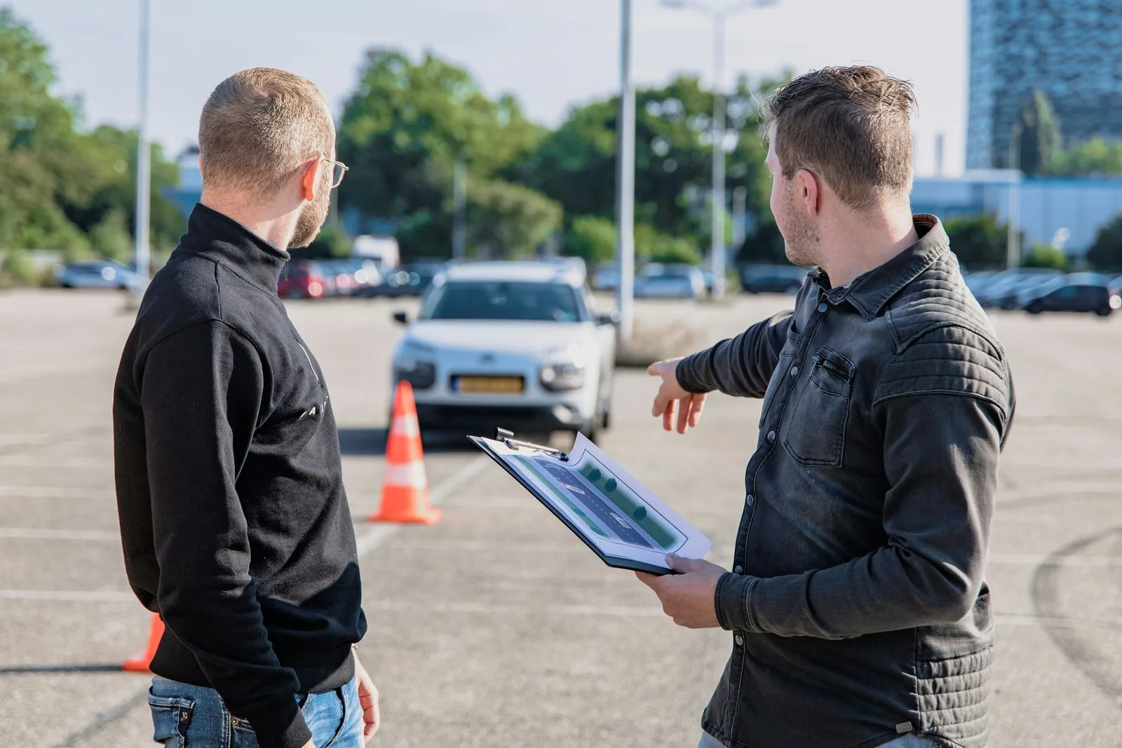Orchard Driving School instructor with student outside vehicle on road test day Edmonton